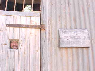 sign on wall says: Historical gaol cells in Cook