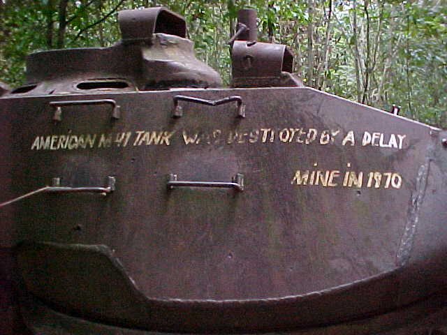 Painted message says: "American tank was destroyed by a delay mine in 1970" :  (Vietnam, The Travel Addicts)