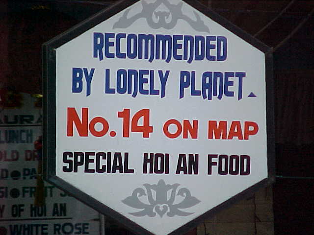 The power of the Lonely Planet : Sign says: Recommended by Lonely Planet \ No 14 on Map \ Special Hoi An food (Vietnam, The Travel Addicts)