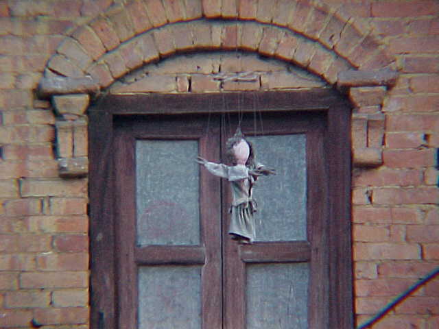 Dolls hanging from eaves (Nepal, The Travel Addicts)