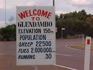 Sign reads: Welcome to Glendambo Elevation 150m Population Sheep 22,500 Flies 2,000,000 Humans 30