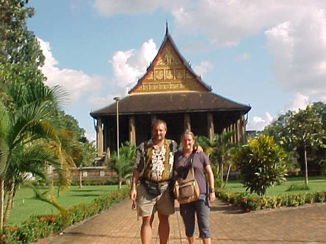 Me and SGK in front of royal temple (Laos, The Travel Addicts)